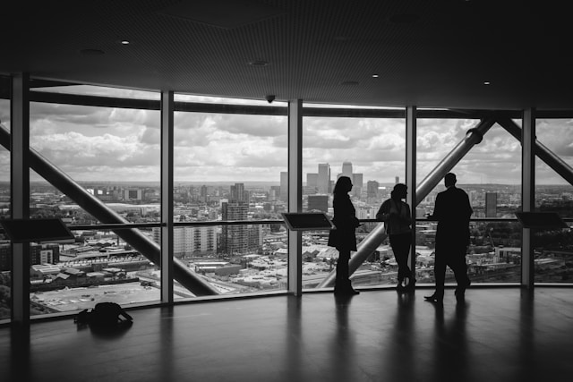 three business people in high rise office building